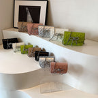 Ladies mini handbag with luxurious quilted pattern and sparkling chain pendant
