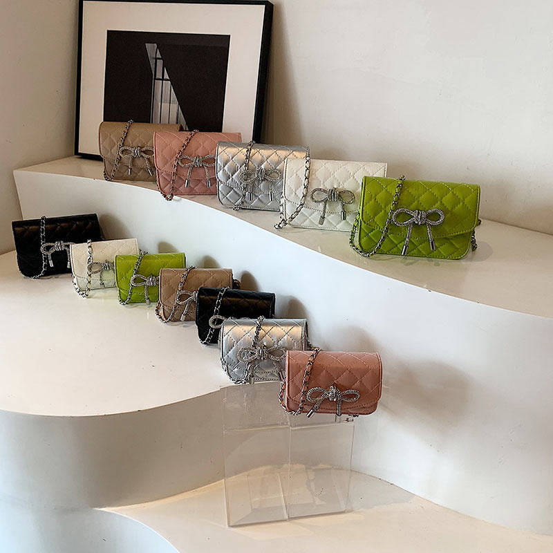 Ladies mini handbag with luxurious quilted pattern and sparkling chain pendant