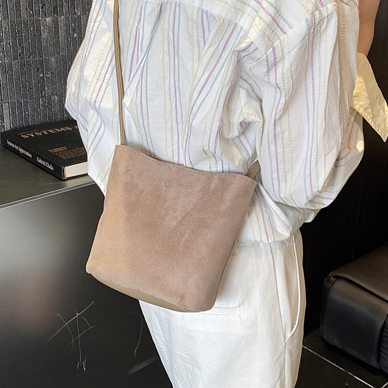 Women's mini bag made of soft suede with adjustable shoulder strap