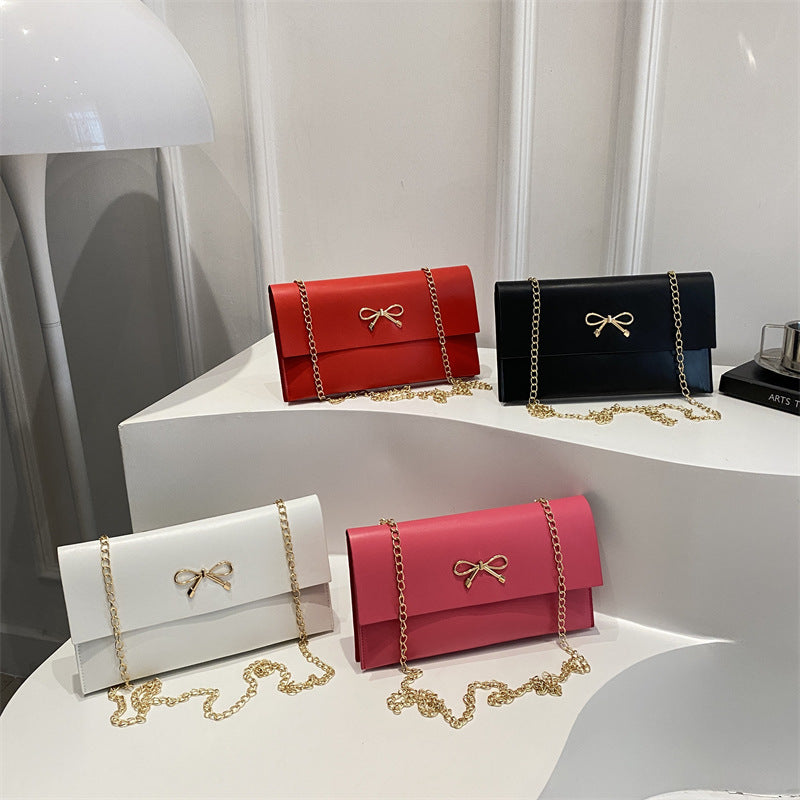 Women's elegant clutch in minimalist design with golden accents