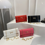 Women's elegant clutch in minimalist design with golden accents