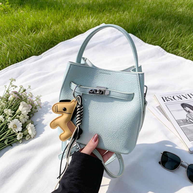 Women’s mini crossbody bag with playful design and cute charm