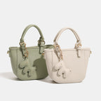 Women's mini handbag with playful animal charm