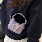 Women’s mini handbag with stylish bow closure