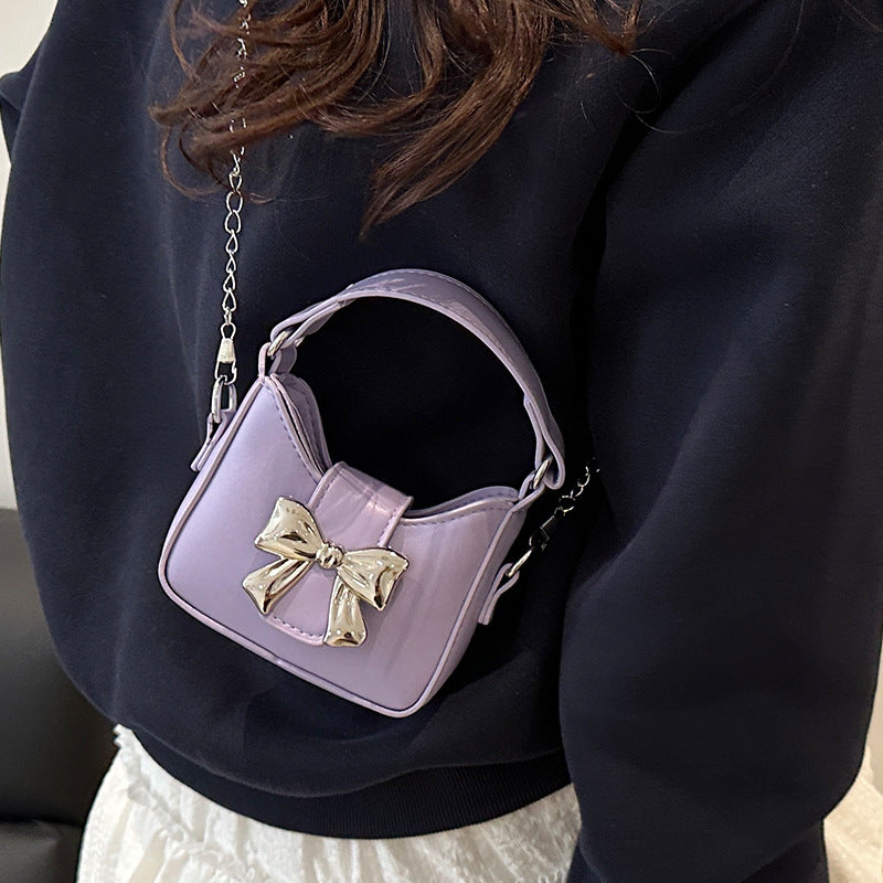 Women’s mini handbag with stylish bow closure