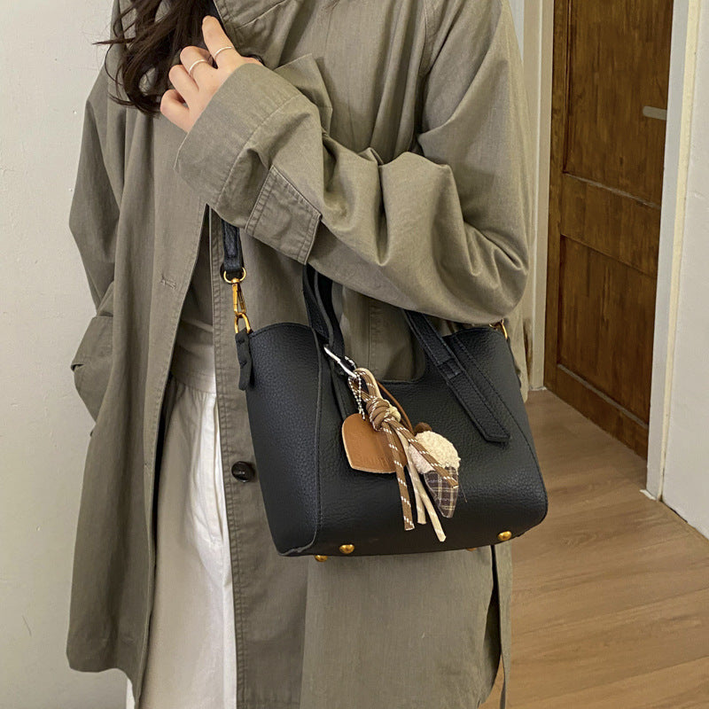 Women's mini handbag in an elegant design with charming pendant