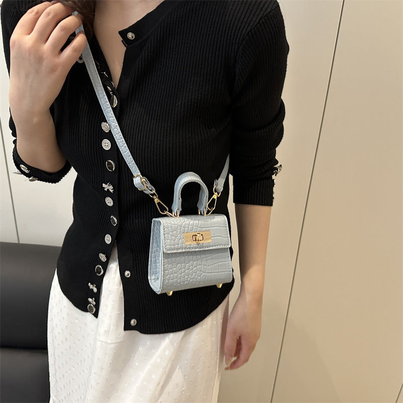 Ladies mini bag with elegant crocodile look and golden accents