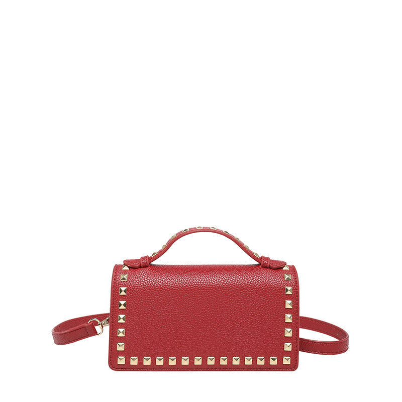 Women's mini handbag with sparkling upper material and golden studs