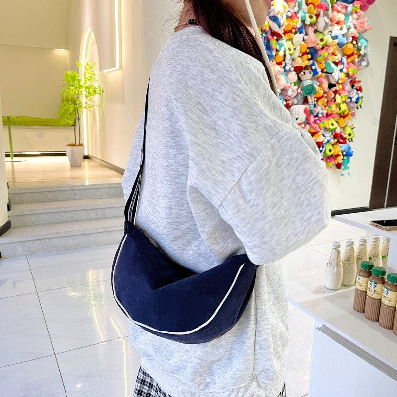 Fashionable shoulder bag with unique cut and adjustable strap