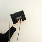 Women's clutch bag with elegant quilting and fine chain strap