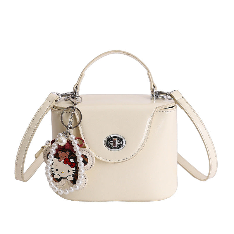Ladies mini handbag in elegantly curved design with playful pendant