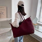 Large travel bag with durable material and multiple compartments