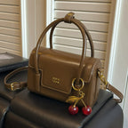 Women's mini handbag with elegant structure and charming pendant