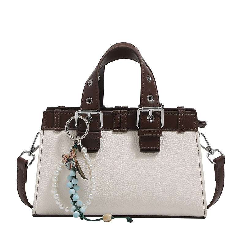 Women's mini handbag with playful pendant and elegant design