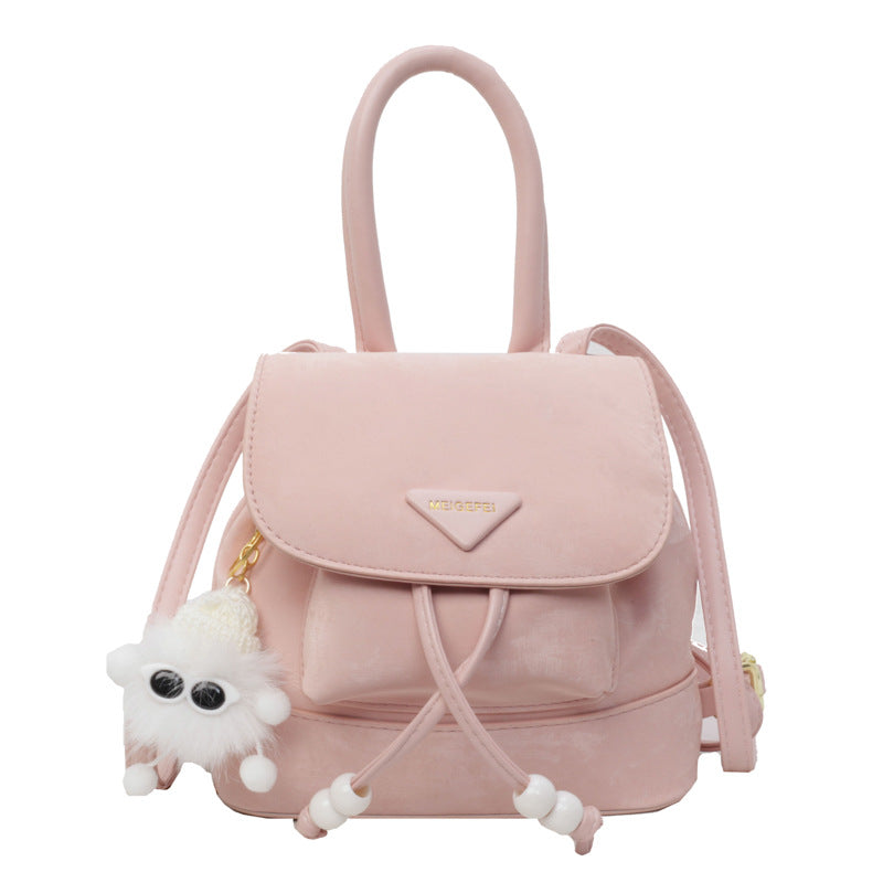 Women's mini backpack with playful design and plush pendant