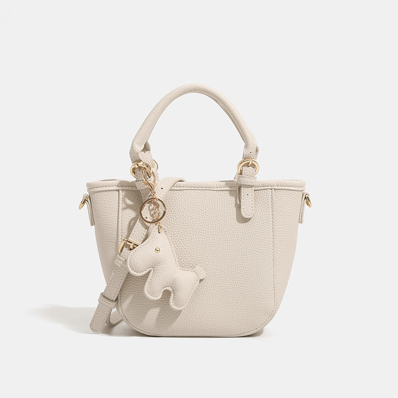 Women's mini handbag with playful animal charm