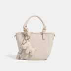 Women's mini handbag with playful animal charm
