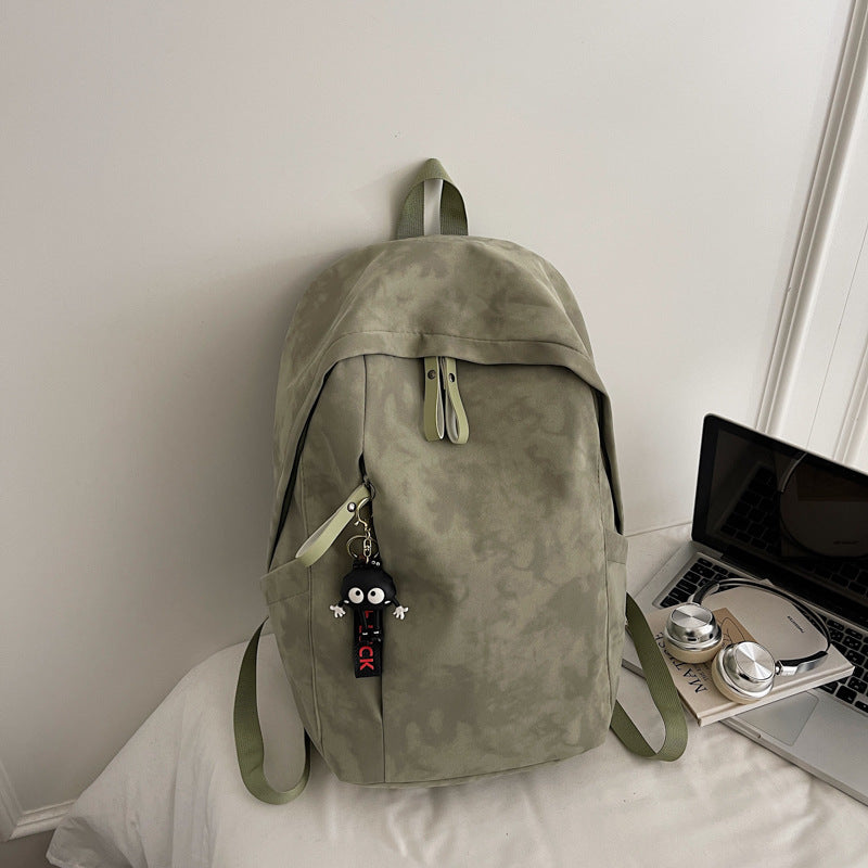 Fashionable backpack with practical design and decorative pendant