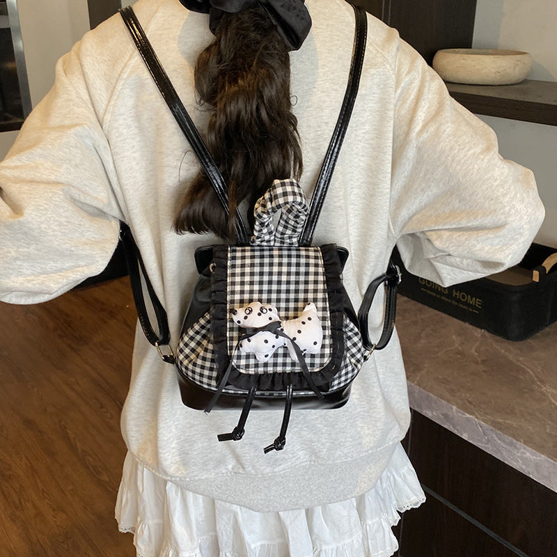 Playful backpack with checkered pattern and animal appliqué