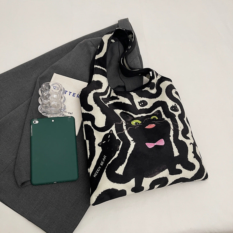 Shoulder bag with playful cat motif