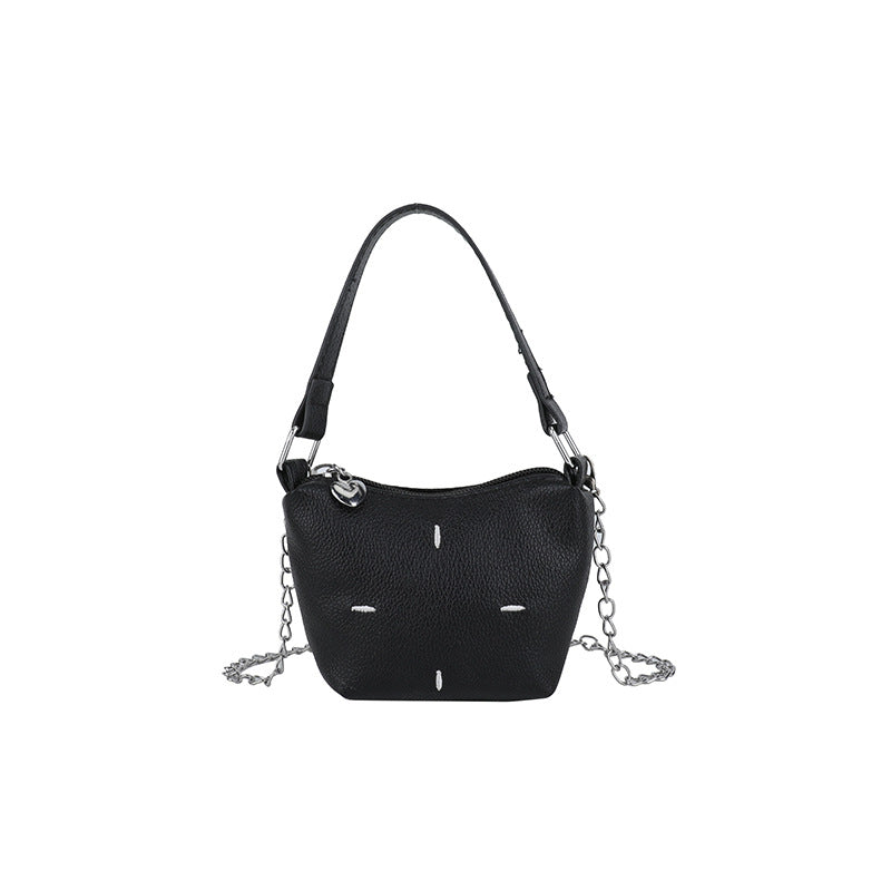 Women's mini handbag with shiny chain and textured upper material