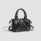 Women's mini handbag with decorative metal accents and removable shoulder strap