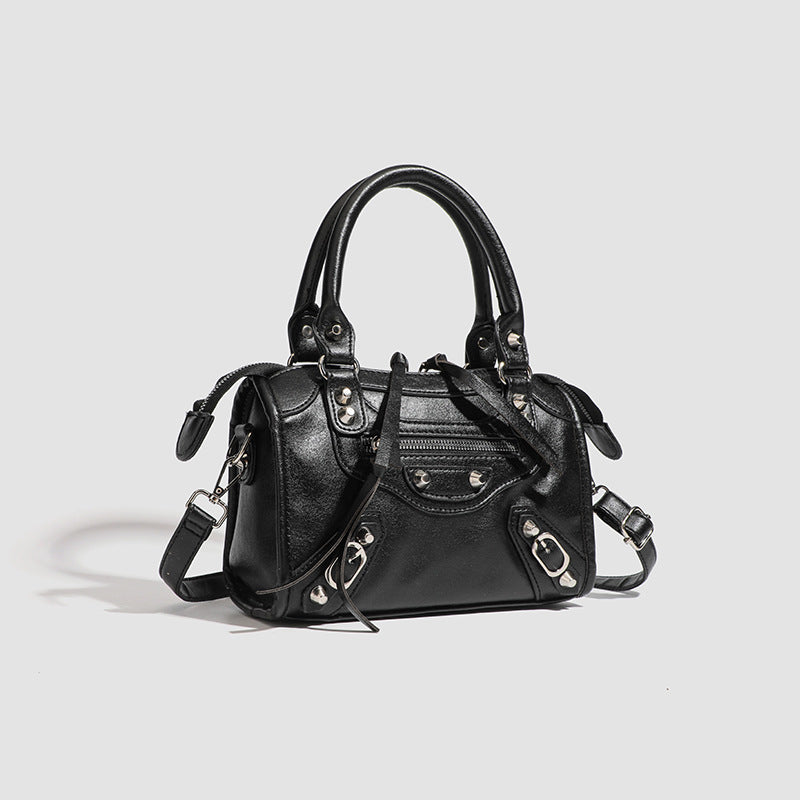 Women's mini handbag with decorative metal accents and removable shoulder strap