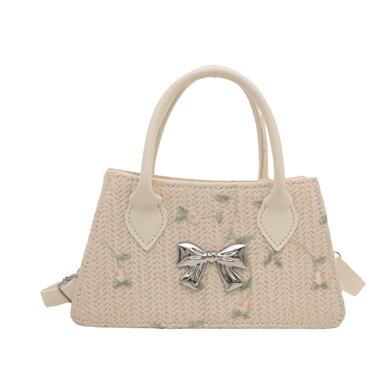 Ladies mini bag with floral woven design and stylish bow detail