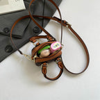 Ladies mini handbag with luxurious accents and adjustable shoulder strap