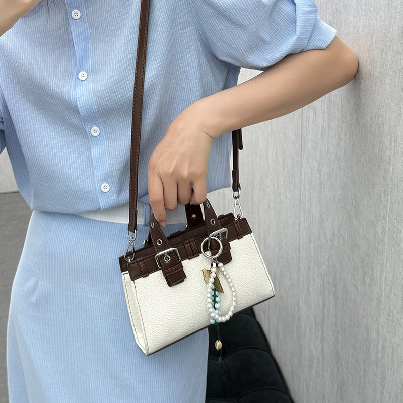 Women's mini handbag with playful pendant and elegant design