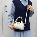 Women's mini bag with playful charm
