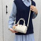 Women's mini bag with playful charm