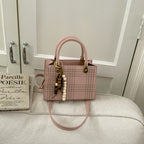Women's mini handbag with elegant structure and golden accents