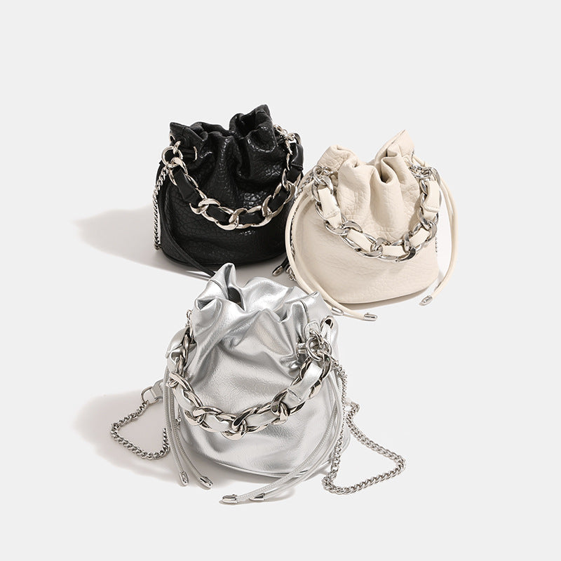 Women's mini backpack bag with elegant chain handle and fine texture