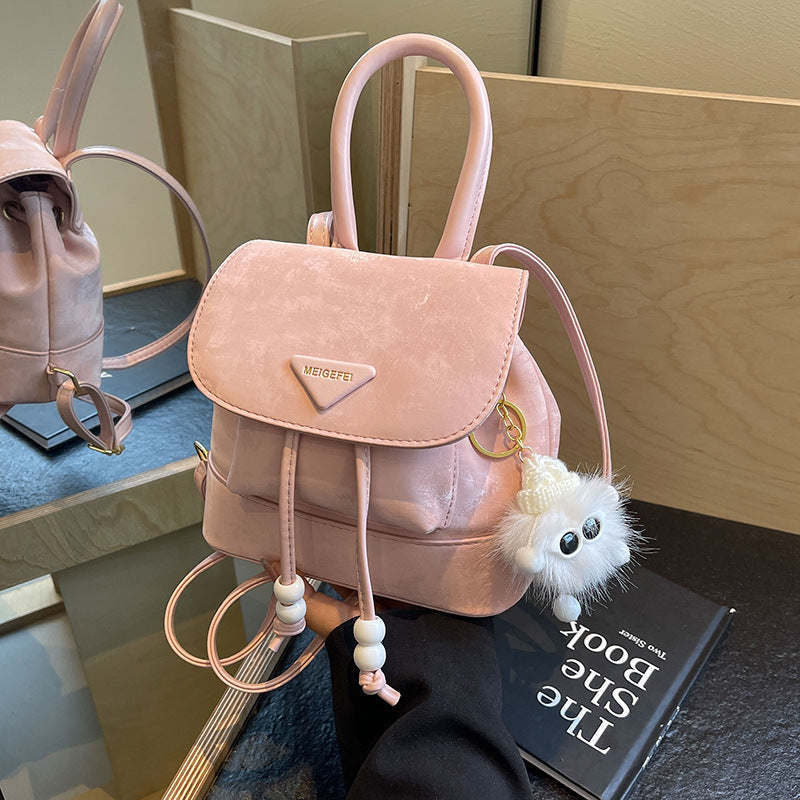 Women's mini backpack with playful design and plush pendant