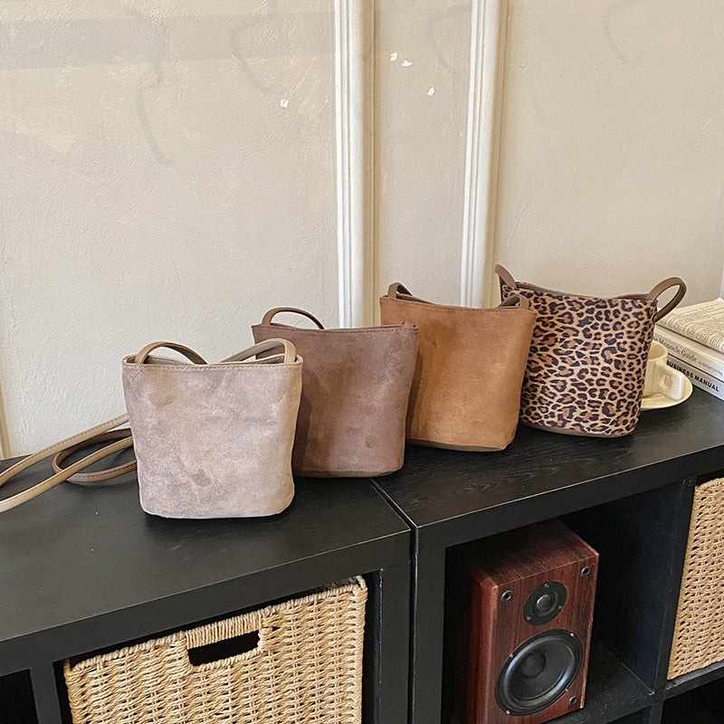 Women's mini bag made of soft suede with adjustable shoulder strap