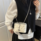 Women's mini handbag with elegant quilting and chain pendant