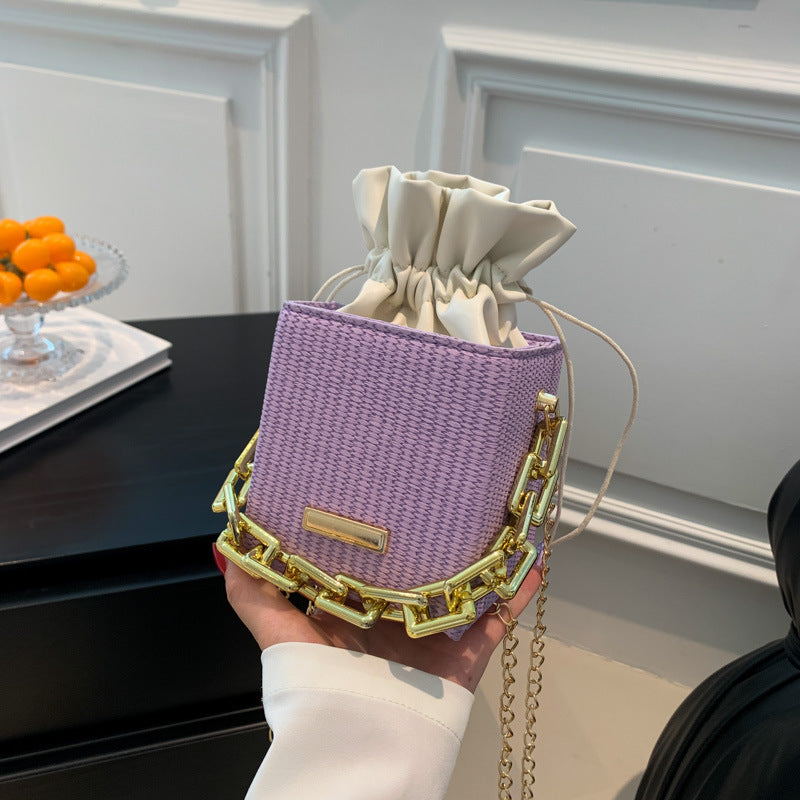 Women's mini handbag with unique chain embellishment and classic drawstring